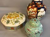 three different colored vases sitting next to each other on a table