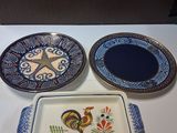 three plates on a table with a rooster on them