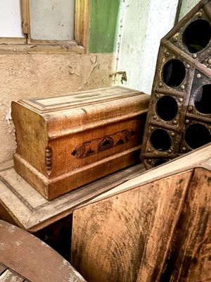 a wooden box sitting on top of a pile of junk
