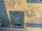 a close up of a piece of wood with a metal latch on it
