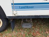 a white truck with a blue stripe on the side of it