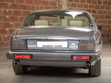 a silver car parked in a garage with a brick wall in the background