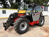 a picture of a small tractor parked in a parking lot
