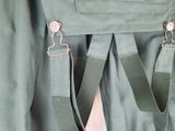 a close up of a green jacket with a pink tie