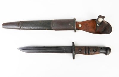 two knives are sitting side by side on a white surface