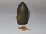 an image of a miniature helmet and a key on a white surface