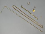 several gold necklaces and bracelets laid out on a table