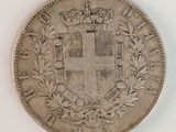 a close up of a silver coin with a crown on it
