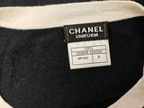 chanel logo on a label on a black and white sweater