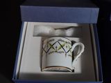 a coffee cup that is in a box on the table
