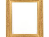 a gold frame on a white wall with a white background