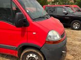 a red van parked in a lot with other cars in the background