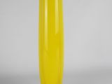 a yellow vase that is sitting on a table