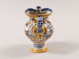 a blue and yellow vase with a bird on it
