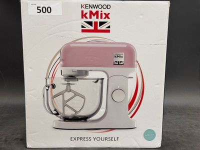 packaging of a pink kenwood mixer sitting on top of a table