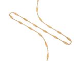 un collier en or composé d'une longue chaîne et d'un pendentif en perle