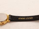 a close up of a watch on a black strap