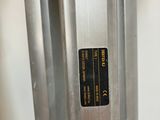 a close up of a metal door handle with a sticker on it
