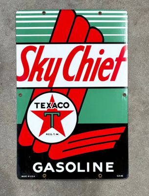 a sign that says sky chief gasoline on the side of a building