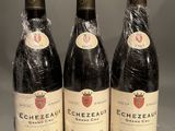 three bottles of wine sitting on top of a table next to each other