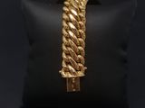 a gold bracelet on a black pillow on a black background