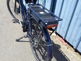 a blue bicycle parked on the side of the road