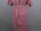 a dress on a mannequin stand with a red and white checkered pattern