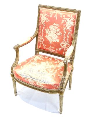 a red and gold chair with a floral pattern on it