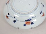 a white bowl with blue and orange flowers on it