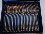 a lot of forks in a blue box on a table