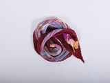 a close up of a red and purple scarf on a white surface