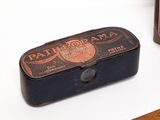 a small black box with a brown label on it