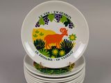 four plates with a deer design on them stacked on top of each other
