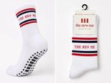 two pairs of socks with the new me logo on them