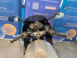 a motorcycle that is parked in front of a blue banner