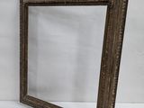 an old wooden frame with a small mirror on it