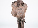 an old wooden statue of a man with a hat on his head