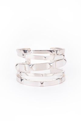 a close up of a stack of silver rings on a white background