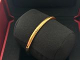 a close up of a gold bracelet in a black box