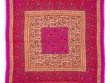 a pink and orange square scarf with a floral design
