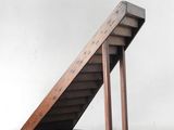 a wooden staircase that is on a wooden stand
