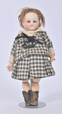 a small doll that is standing on a stand