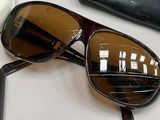 a pair of sunglasses sitting on a table next to a pair of glasses