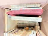 a box full of books that are stacked on top of each other