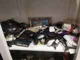 a white shelf with a bunch of electronics on top of it