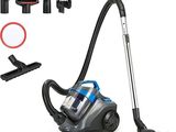 un aspirateur posé sur le sol à côté d'autres objets