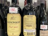 several bottles of wine are lined up on a shelf