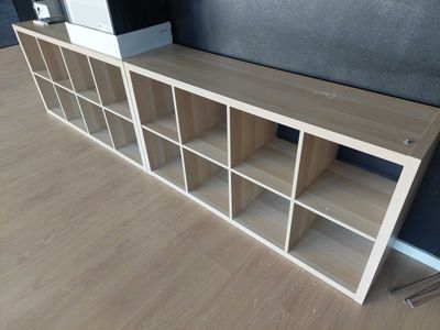 a wooden shelf with several shelves on it in a room