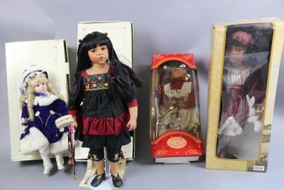 three dolls are sitting next to each other on a table