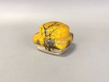 a picture of a yellow and black figurine of a man and a dog